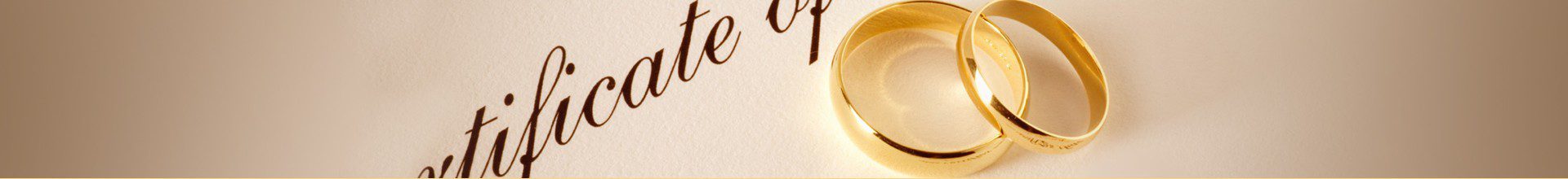 Gold rings on a certificate background.