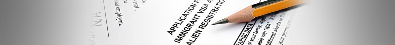 Application form for an immigrant visa with a sharpened pencil, emphasizing the process of completing immigration paperwork.
