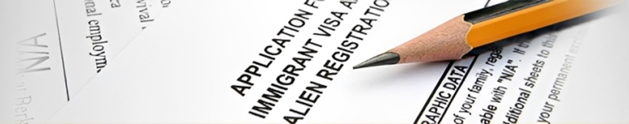 Application form for an immigrant visa with a sharpened pencil, emphasizing the process of completing immigration paperwork.